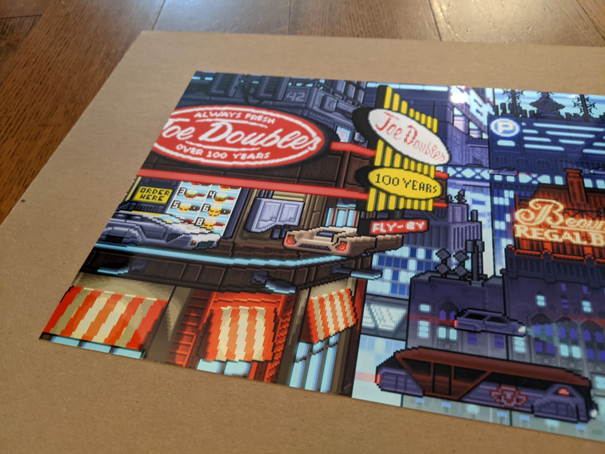 Photographic print depicting a cyberpunk Toronto laying on a piece of cardboard.